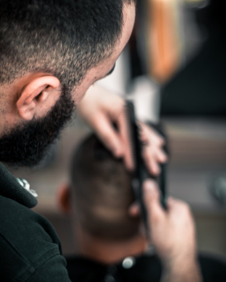 Barber trimming a beard