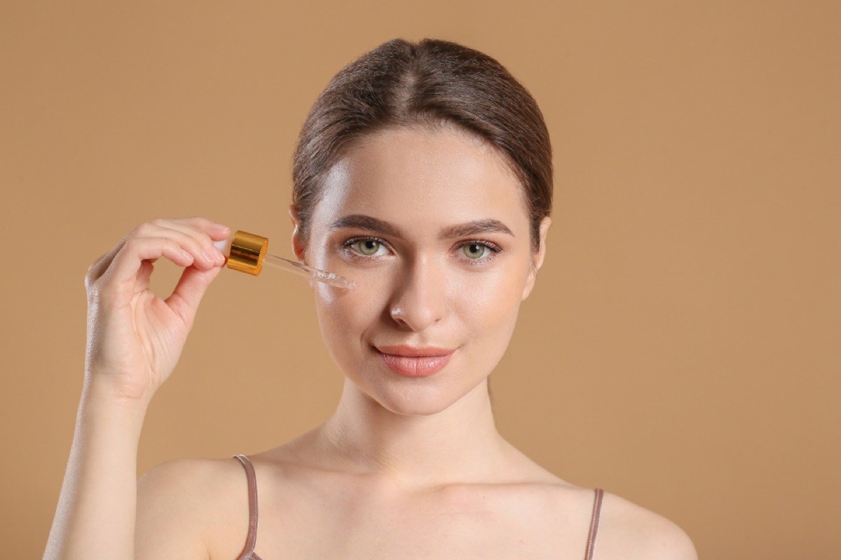 Woman applying a facial serum
